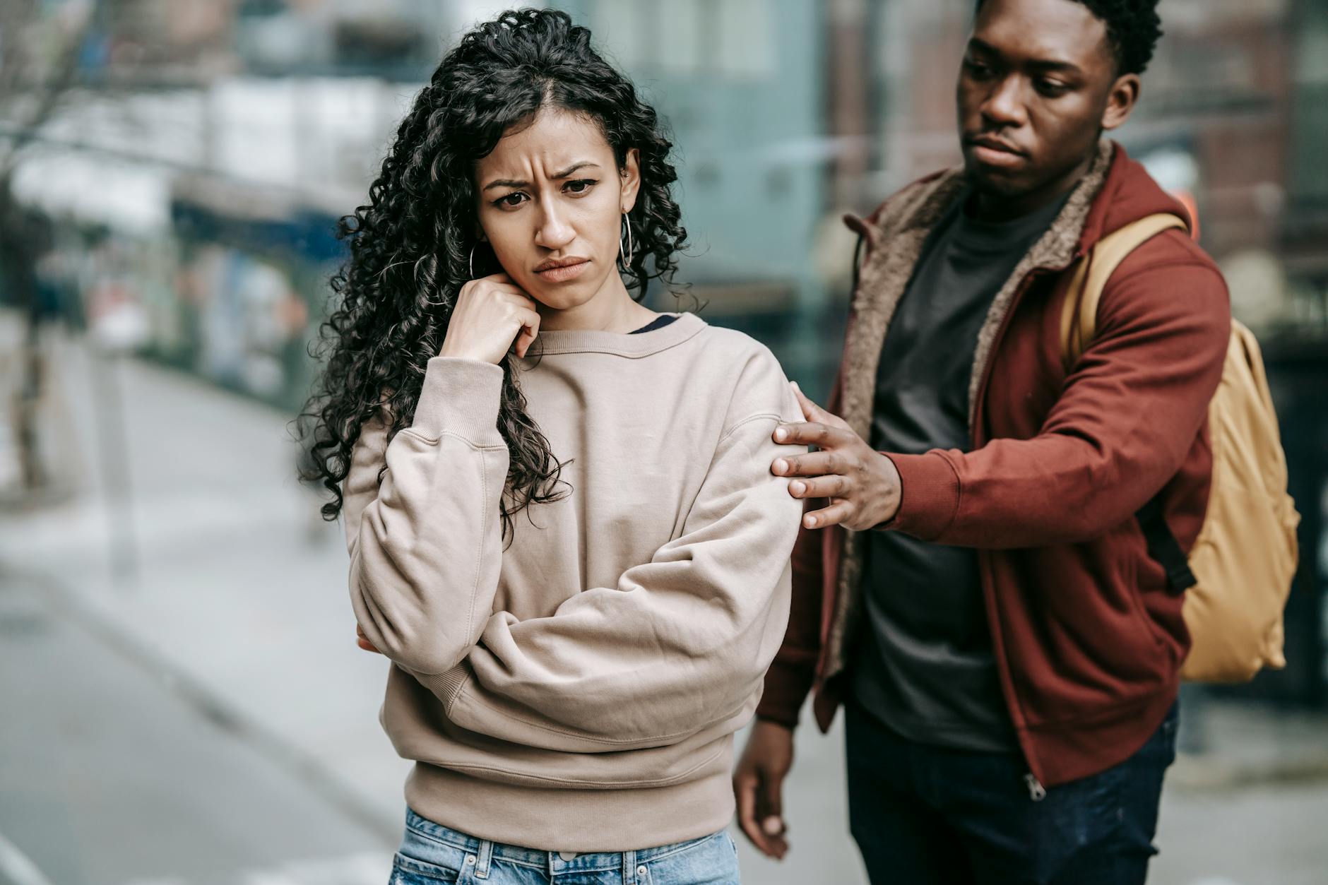 multiracial couple arguing with each other in street