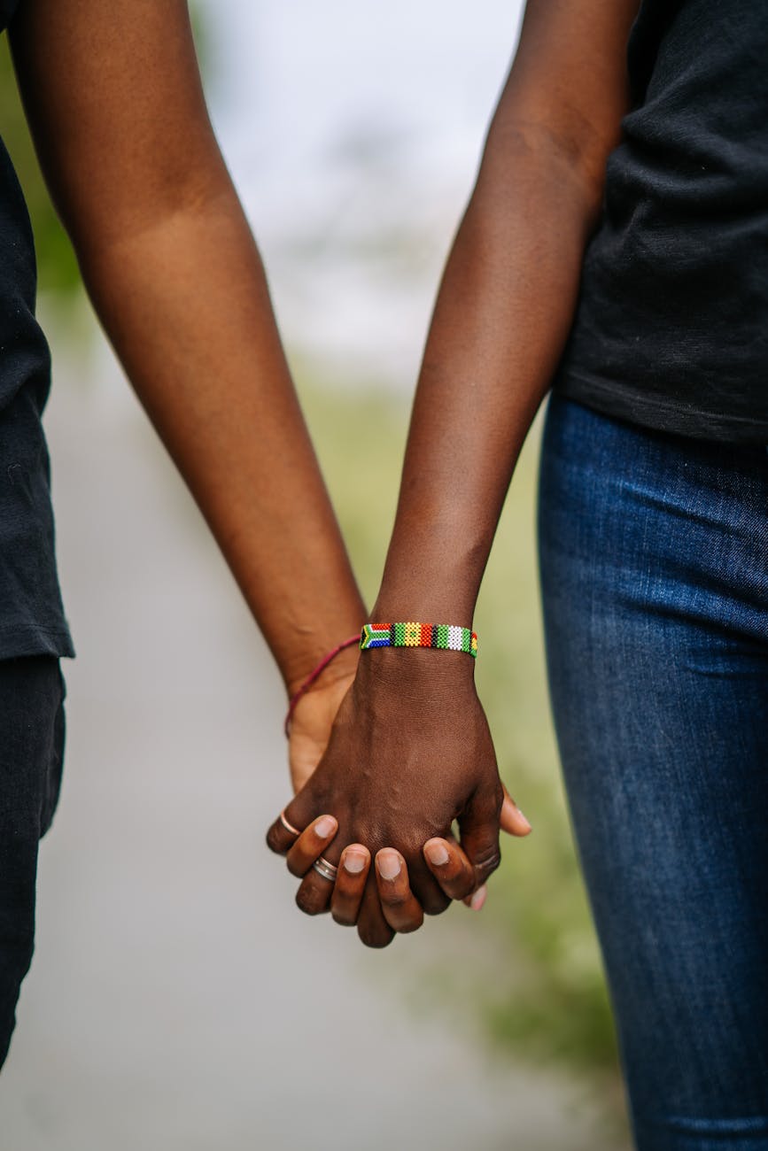 close up photo of couple holding each other s hands