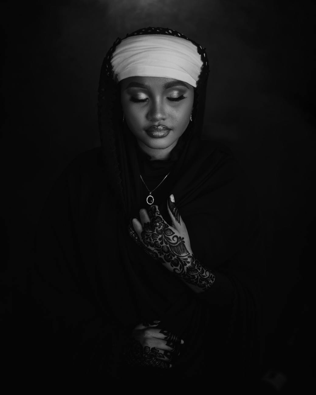black and white portrait of woman with henna art