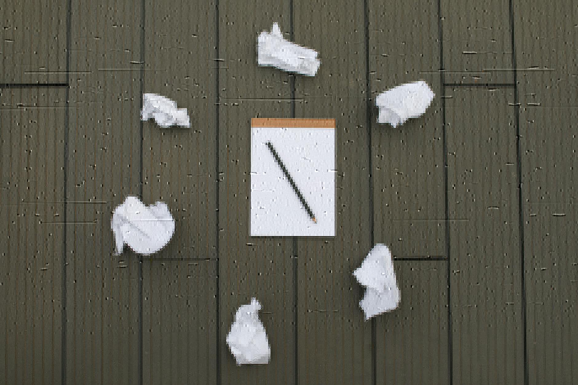 photograph of crumpled paper near a pencil