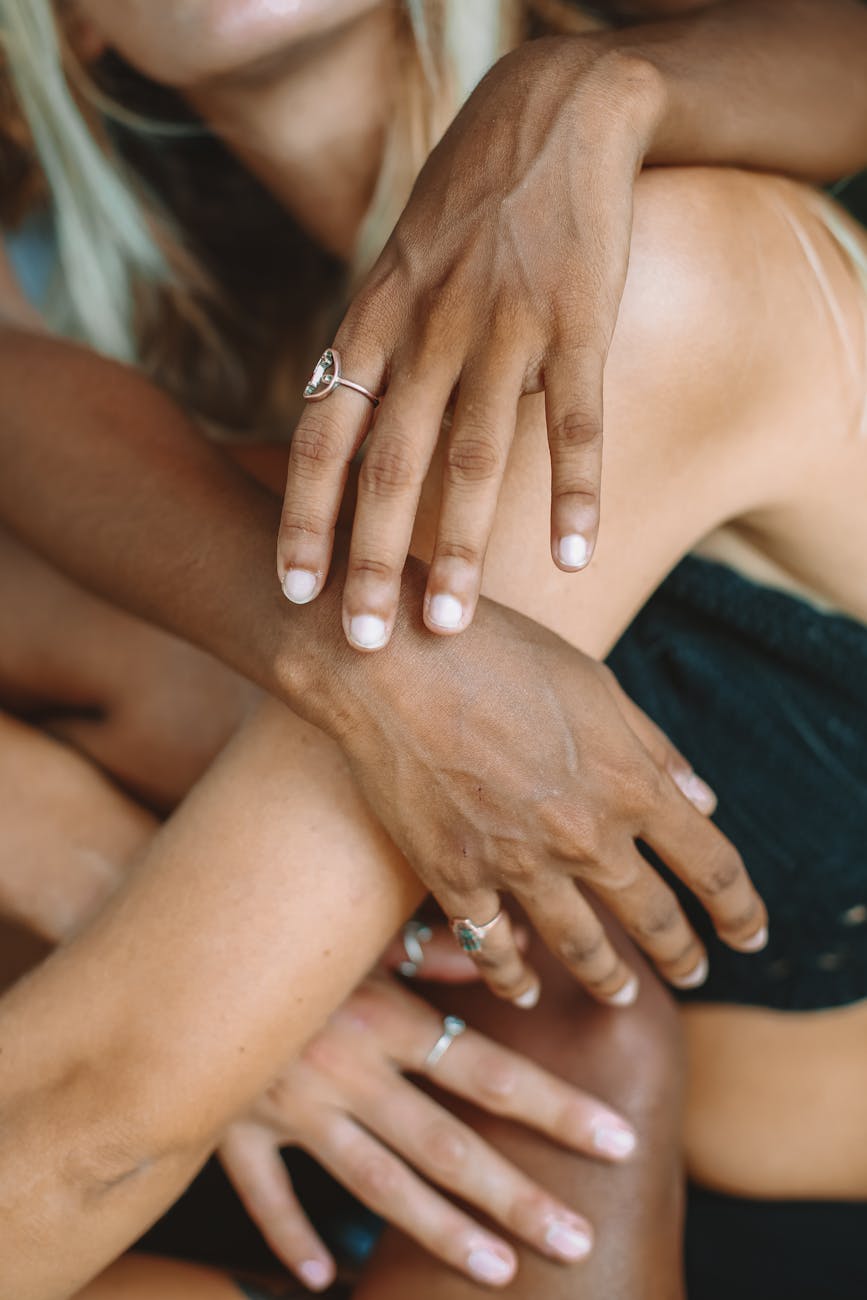 close up photo of hands with silver rings