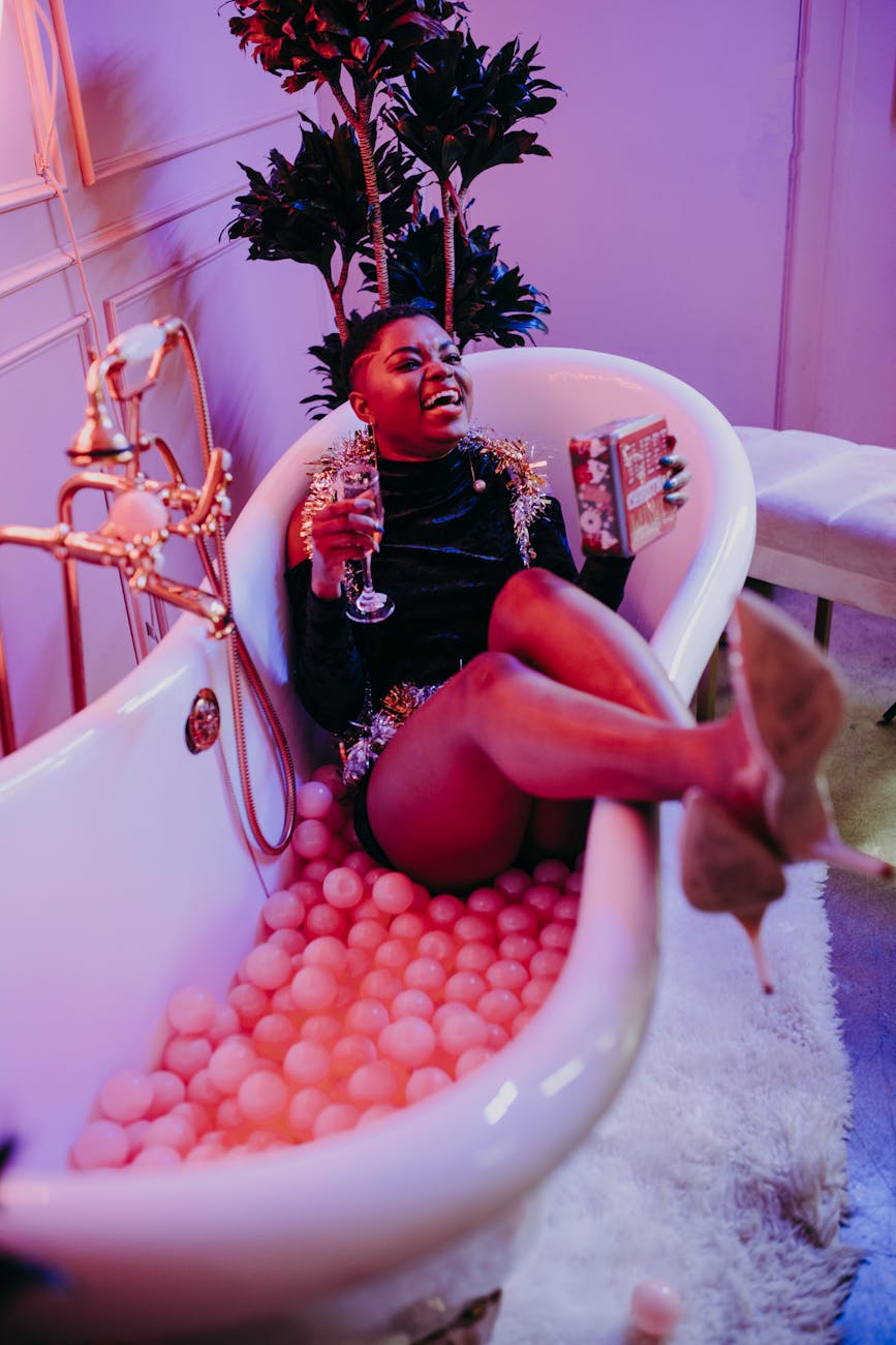 woman drinking wine inside a bathtub