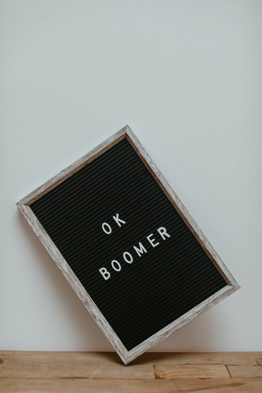 a letter board leaning on a white wall on a wooden surface