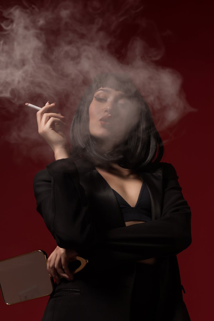 stylish woman smoking with dramatic lighting