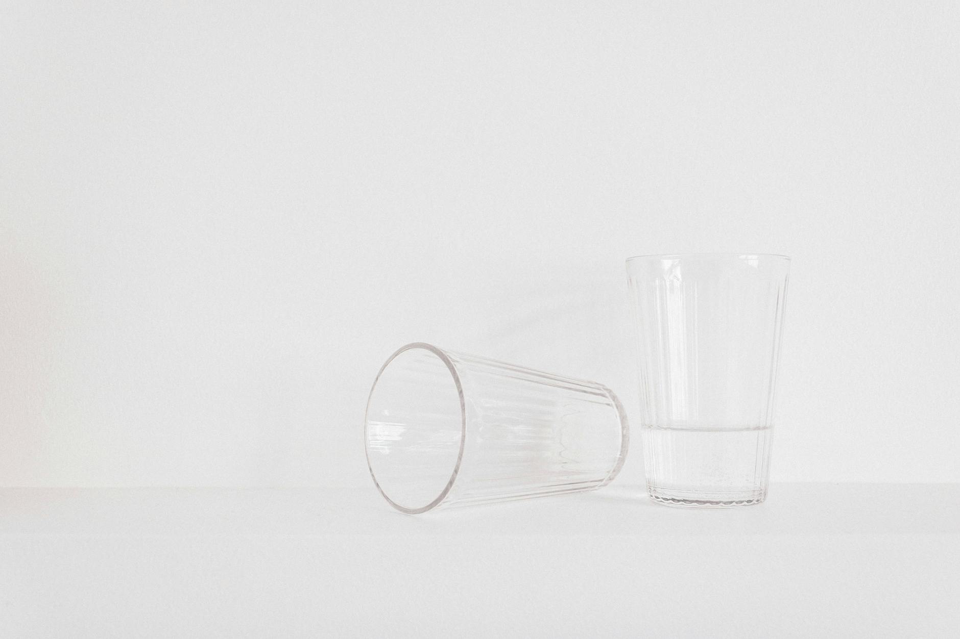 two clear drinking glasses on table