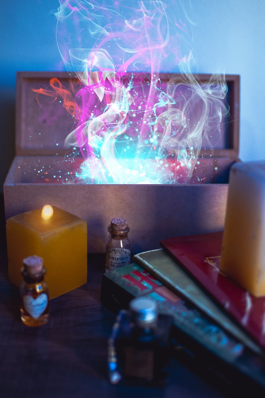 white pillar candle beside clear glass bottle