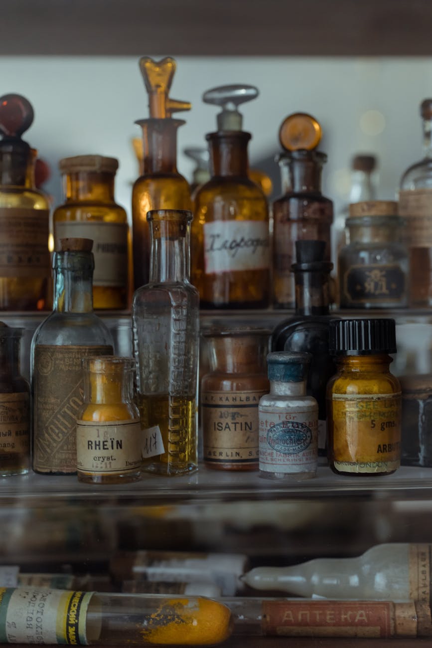 assorted small glass bottles of medicines